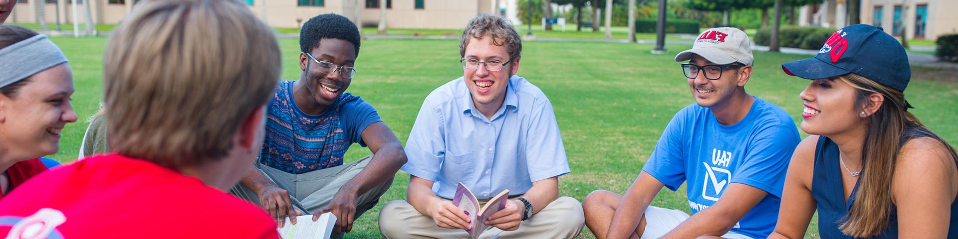 Students sitting on the lawn in a circle